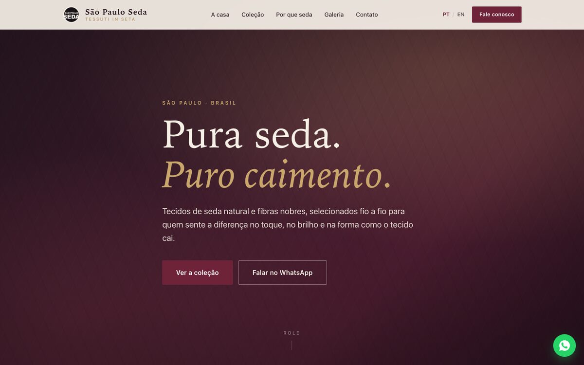 Página inicial da São Paulo Seda, fundo vinho e o título “Pura seda. Puro caimento.”, com alternador de idioma PT/EN.
